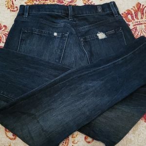 A pair of 7 for All Mankind blue jeans